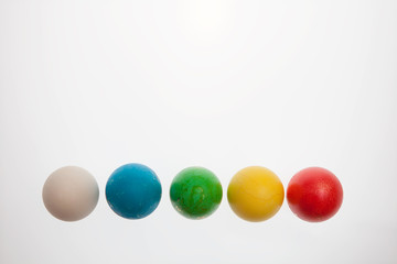 Five Easter eggs on pedestals on a white background
