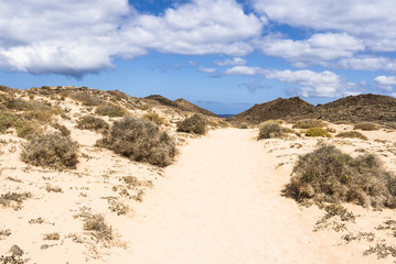 Hiking path on the Canary Islands Fuerteventura Los Lobos to the lighthouse Faro de Martiño.