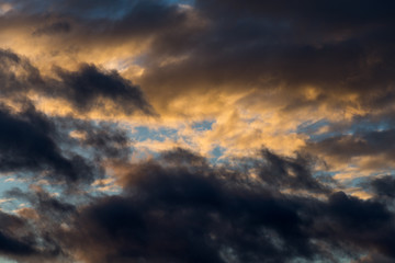 Naklejka na ściany i meble Abstract dramatic sky background with fluffy sunset clouds, cloudscape pattern, copy space