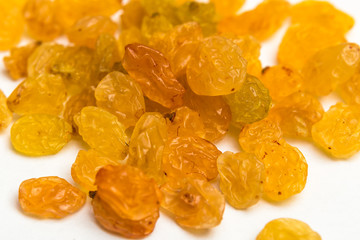 Macro photo of organic dried golden raisins on white background 