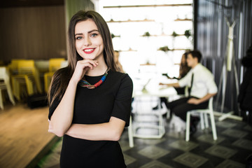 Portrait of smiling businesswoman in front of diverse business team.