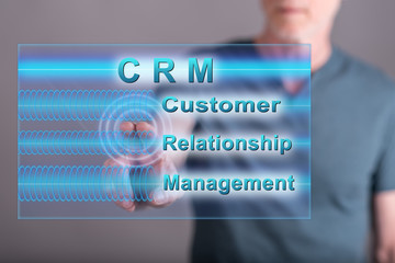 Man touching a crm concept on a touch screen