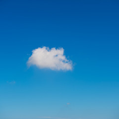 single white cloud against the blue sky..