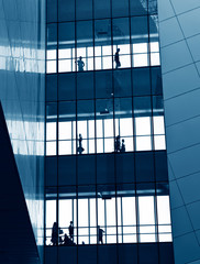 Fototapeta premium silhouettes of business people rushing at morden office building.