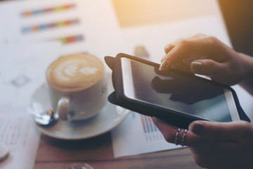 Women hands holding the phone with above the table