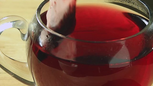 
    tea bag is lowered into the cup 