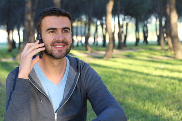 Gorgeous man calling form the park with joy
