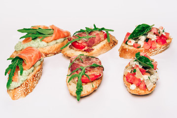Six bruschettes with greens, cheese, meat and fish