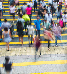 Busy city people on zebra crossing street in Hong Kong, China.