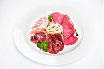 Dish of various types of meat-cutting on plate.