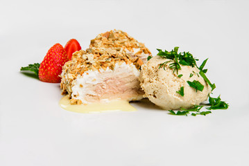 Meat covered in crumpet of pumpkin seeds served on plate.