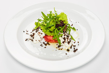 Vegetable salad with white sauce and grilled crumbs on plate.