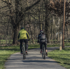 Man and woman on bicycles in sunny spring day