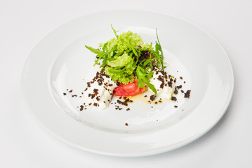 Vegetable salad with white sauce and grilled crumbs on plate.