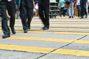 Fototapeta na wymiar Busy city people on zebra crossing street in Hong Kong, China.