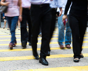 Fototapeta na wymiar Busy city people on zebra crossing street in Hong Kong, China.