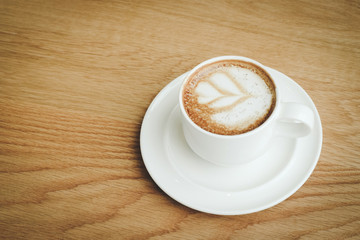 Cup of coffee on wood background, retro style, with copy space
