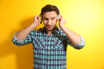 Handsome young man posing on color background