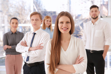 Young woman with group of people on background © Africa Studio