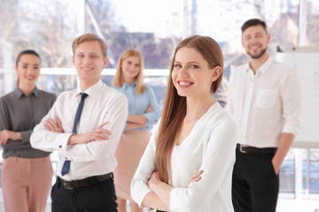 Young woman with group of people on background © Africa Studio