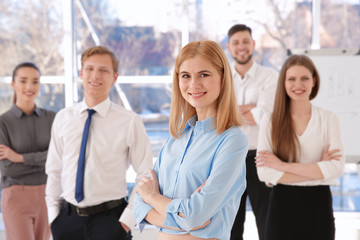 Young woman with group of people on background © Africa Studio