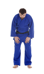 Young sporty man in kimono on white background