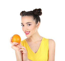 Beautiful young woman with orange on white background