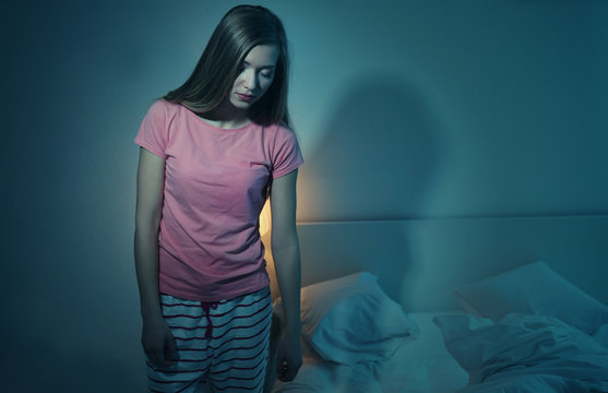 Young sleepy woman suffering from somnambulism at home