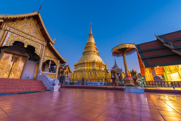 Hariphunchai massive gold stupa of Lamphun province, the tourist attraction of northern Thailand. This temple is very old and large with a museum with artefacts from the 12 th and 13th century © phichak