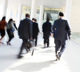 Business people rushing in the lobby. motion blur