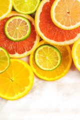 Fototapeta na wymiar Grapefruit, lime, lemon, and orange slices with copyspace