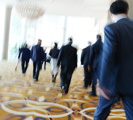 Business people rushing in the lobby. motion blur