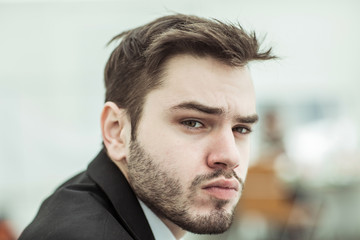 portrait of successful businessman on background of office