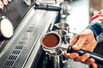  Close up image of a man making coffee.