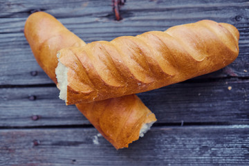 Delicious french baguette on a grey wooden table.
