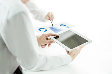 business team using digital tablet analyzes the marketing report