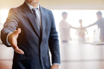 Businessman Offering Handshake in meeting room. Success Concept.