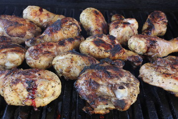 Assortment of chicken on a charcoal BBQ grill