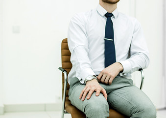 concept of business success - businessman sitting on a chair in 