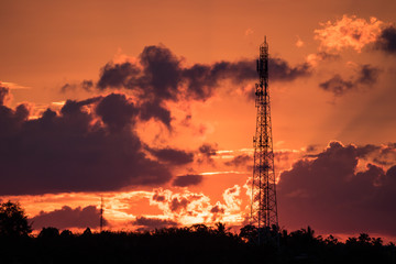 Fototapeta premium radio towers with sunset sky in background