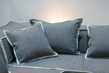 Modern fabric gray pillow on luxury fabric sofa interior