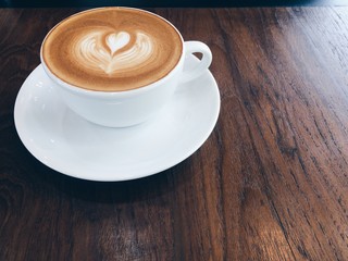 Hot coffee with cup on old wood background.