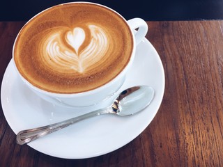 Hot coffee with cup on old wood background.