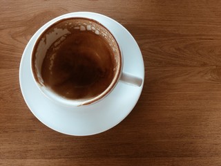 Hot coffee with cup on old wood background.
