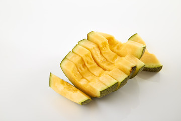 Hamigua Melon cut into slices, Hami Melon, Hami Cantaloupe isolated on white background.