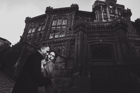 Fashion couple photo with sharp sunlight. Background of  Rum Ortodoks Patrikhanesi Cathedral