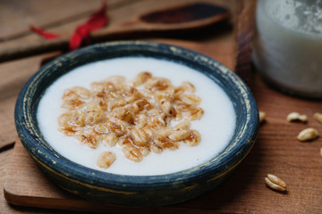 Dish of cereal with milk and wooden spoon 