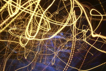 Abstract colored lines in darkness