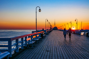 Fototapeta premium Wschód słońca przy drewnianym molo w Sopocie