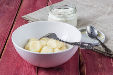 Traditional russian, ukrainian cottage cheese lazy dumplings served with sour cream and cherry